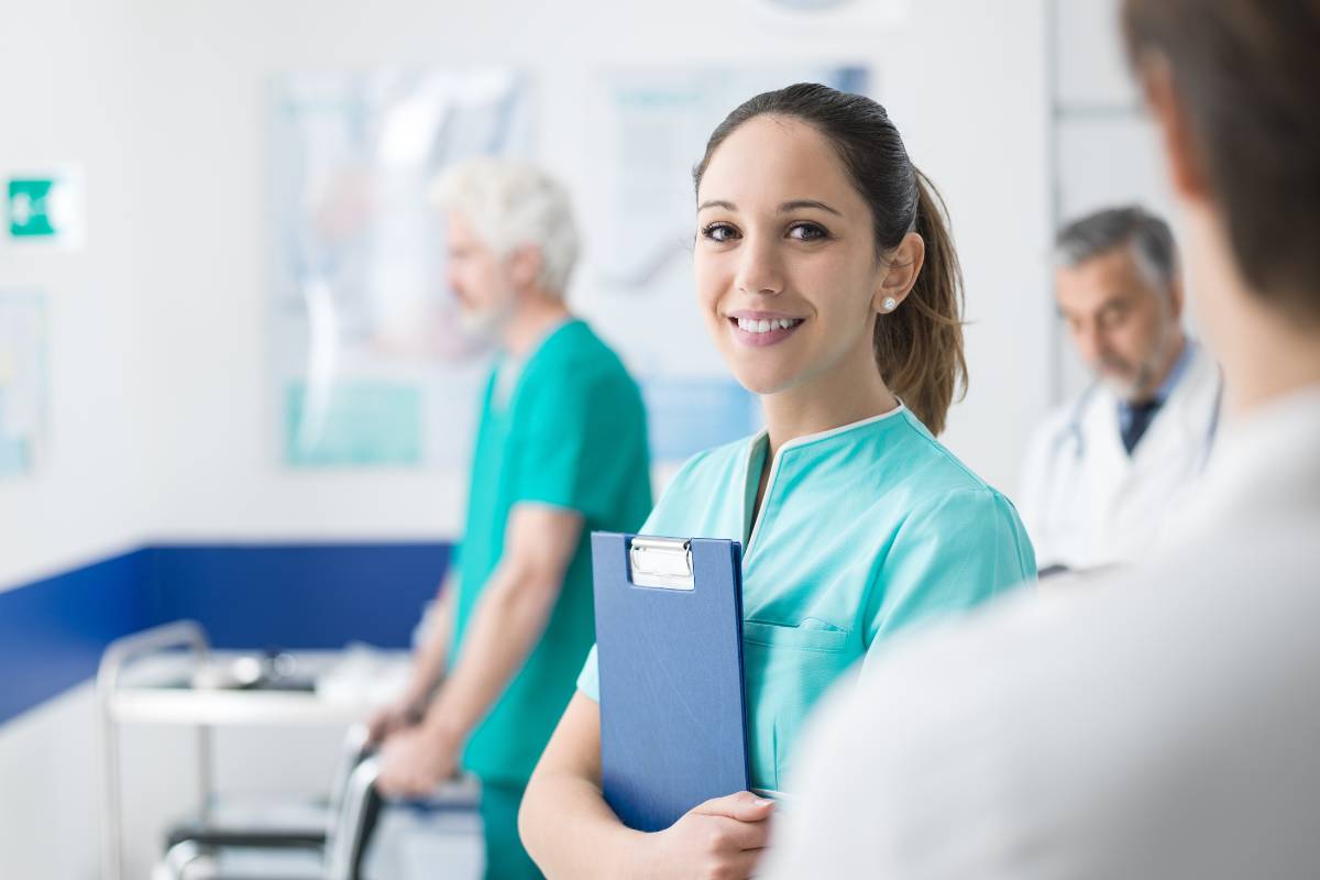 A nurse poses for a photo while discussing how to become a registered nurse in Wisconsin.