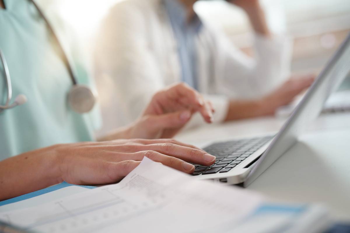 A nurse works on their STNA cover letter to prepare for a job.