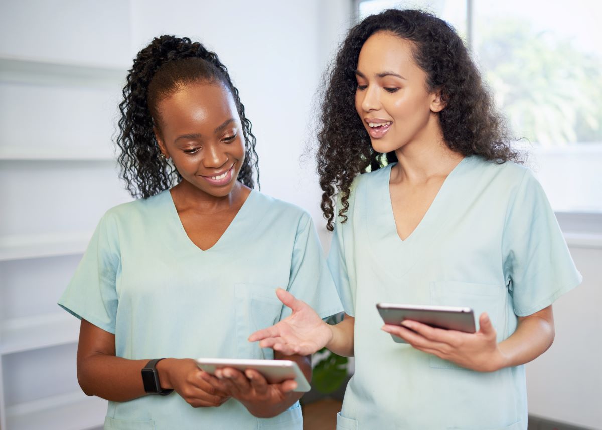 Two nurses using the CMS IOM.