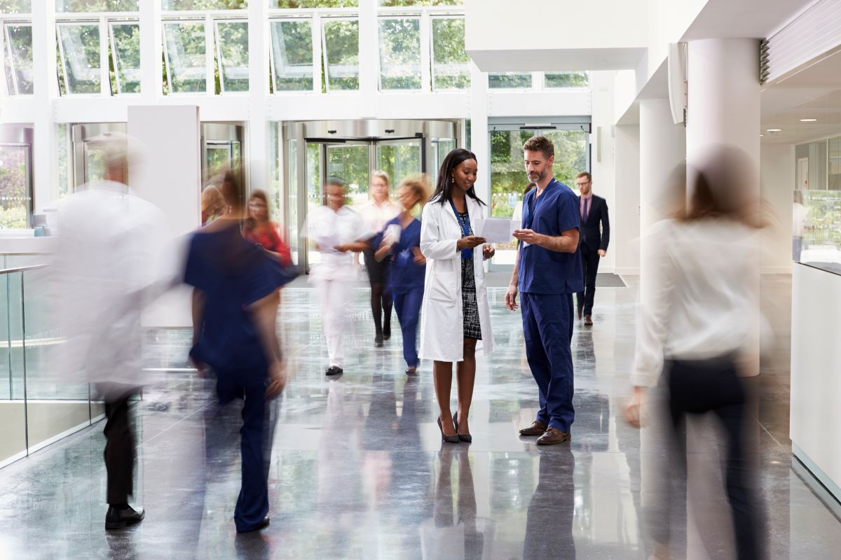 Camera focuses on a nurse and a physician at a critical care hospital.