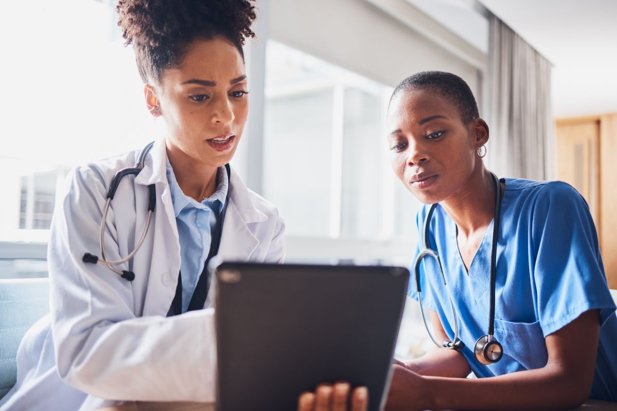 A nurse delegates tasks to a CNA.