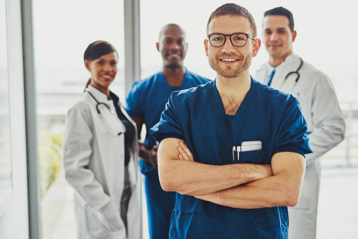 A man in blue scrubs uses his director of nursing resume to get his dream job.