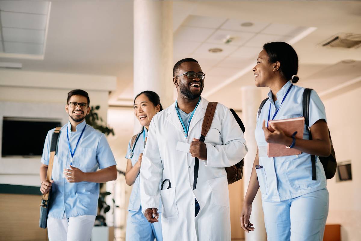 A group of students discuss the Dorothy Johnson nursing theory after a class.