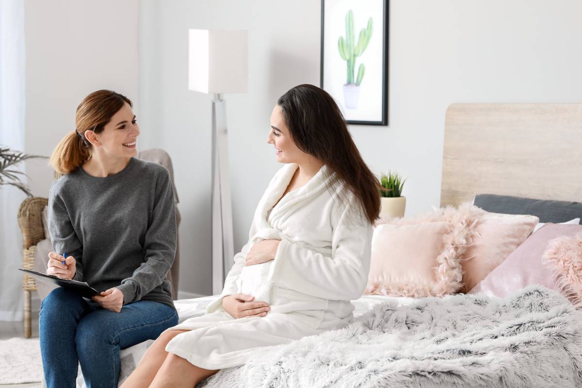 A doula practices their doula resume skills while speaking with a patient.
