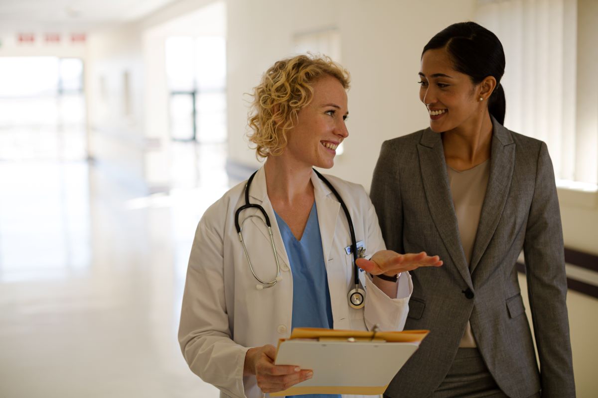 A physician meets with a member of the administrative team.