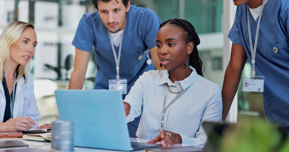 A group of doctors and nurses gather with a quality control manager to discuss improvement measures.