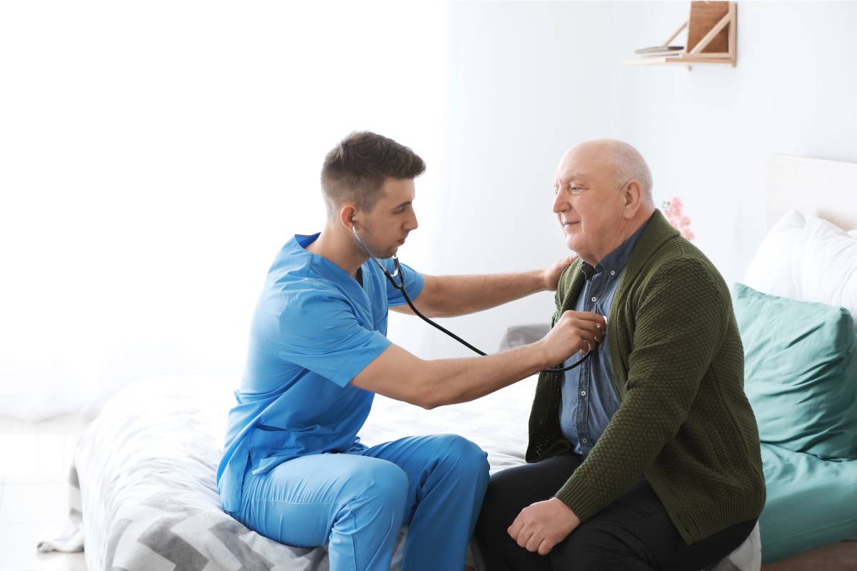 A holistic nurse practitioner checks a patient's heart.