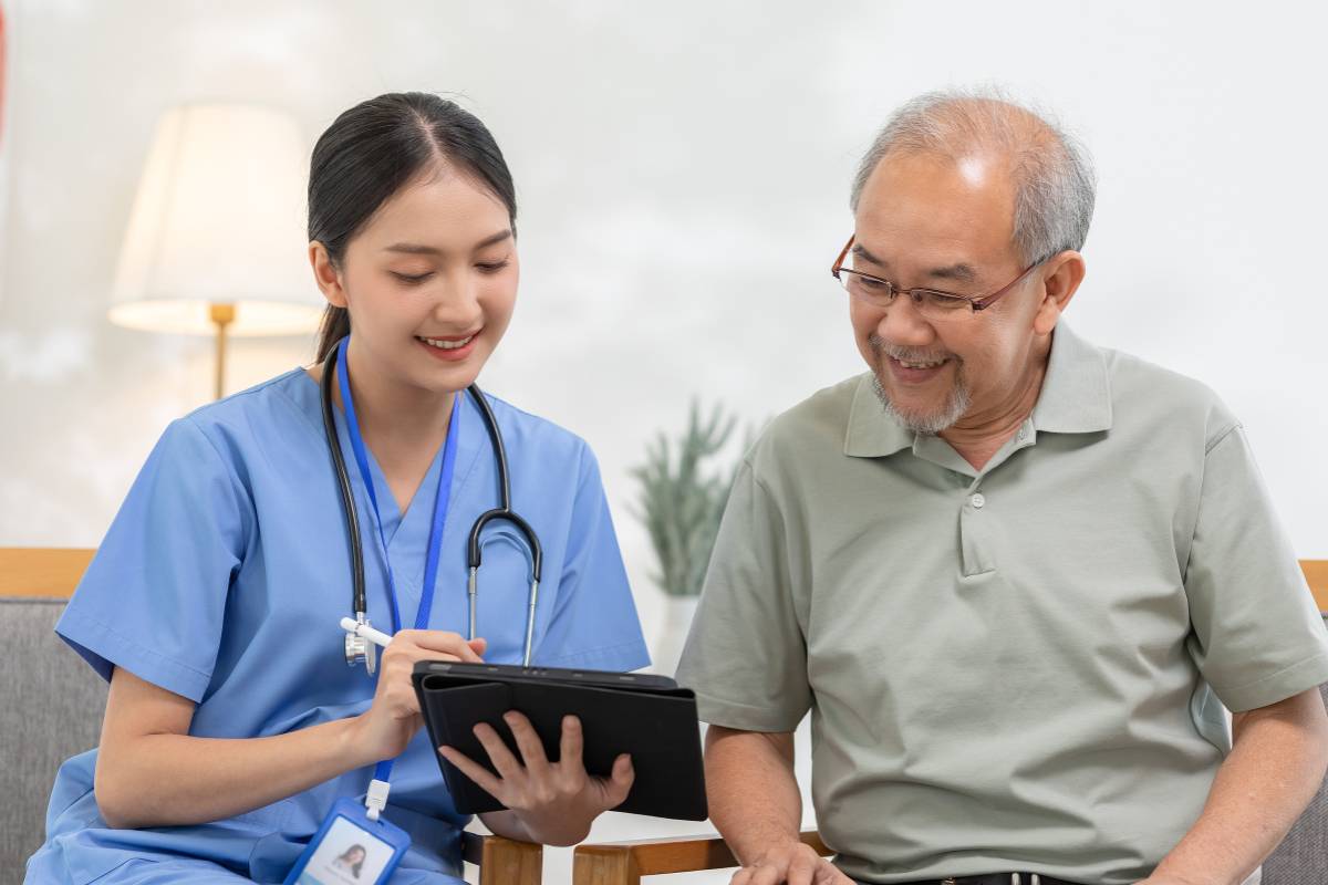 A nurse speaks with a patient about how to become an RN in Rhode Island.