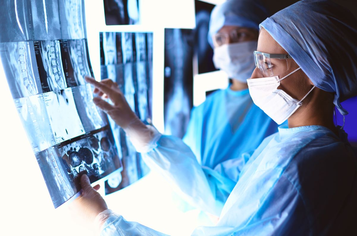 Two IR nurses examine X-rays.