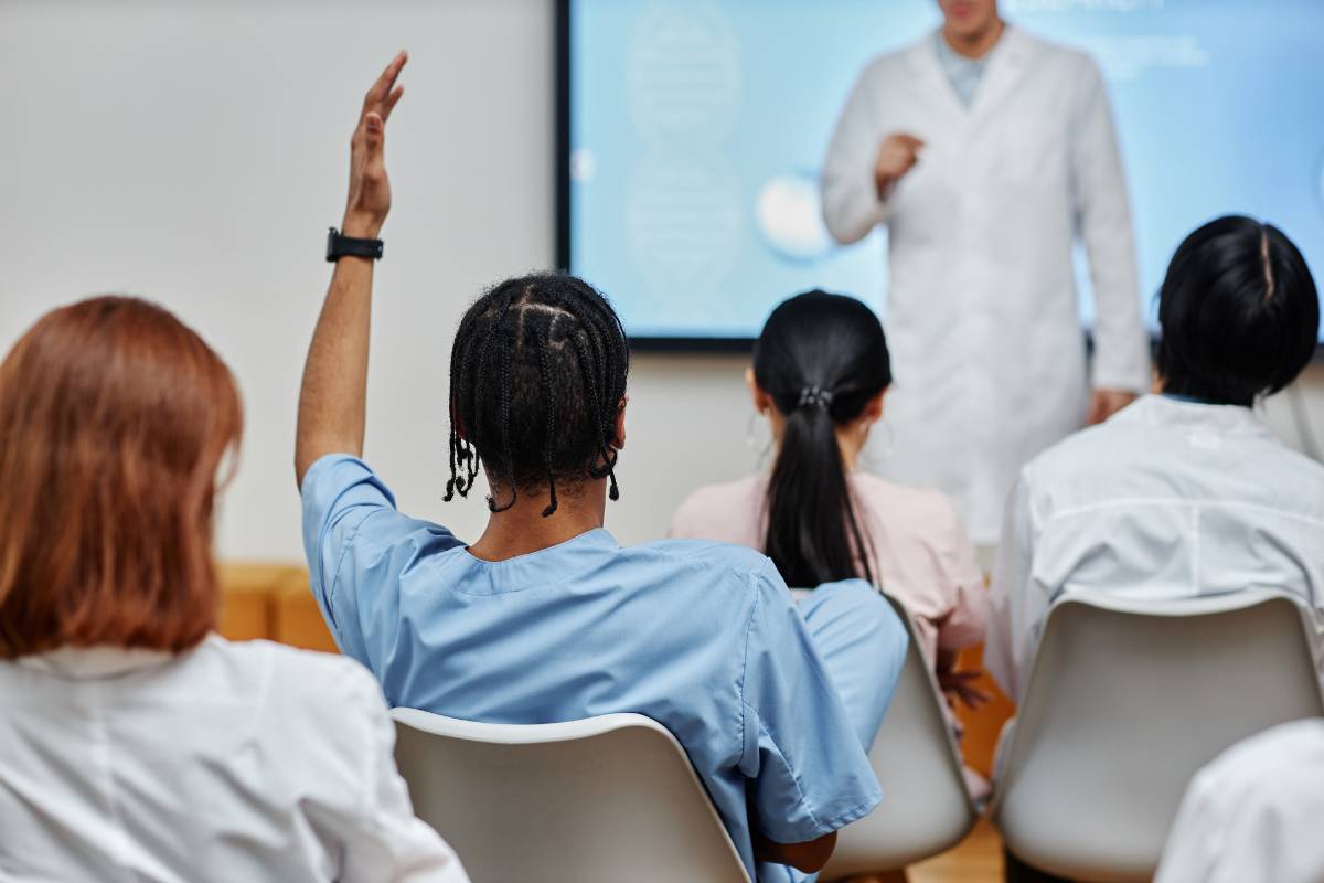 A nursing student asks a question about Katharine Kolcaba in class.