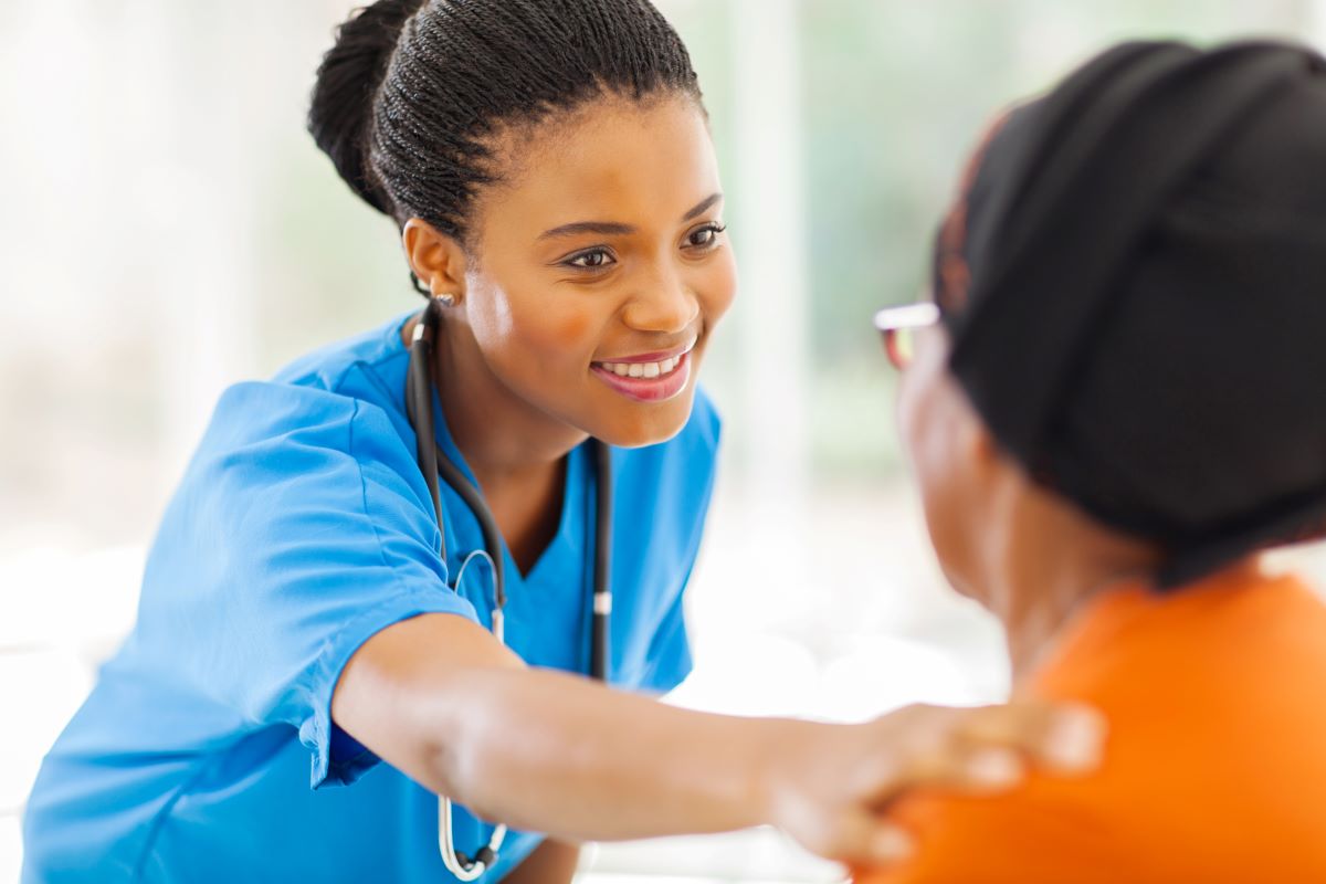 An LPN consoles a patient.