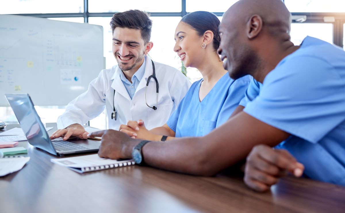 A team of nurses and physicians figuring out how best to promote their facility using social media marketing techniques.