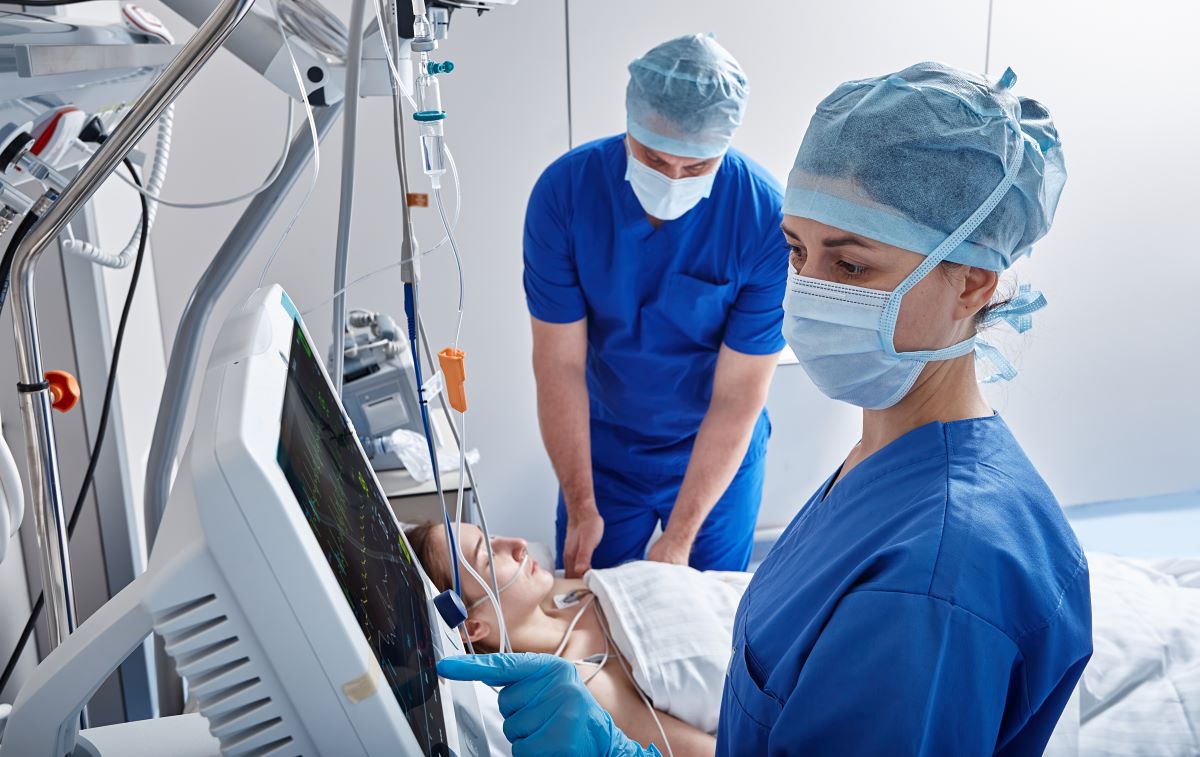 Med surg nurses help a patient after surgery.