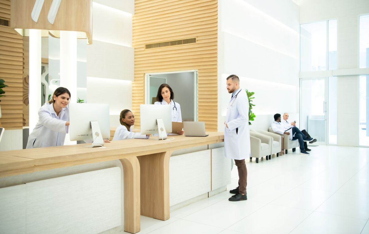 Medical building waiting room with doctors and patients