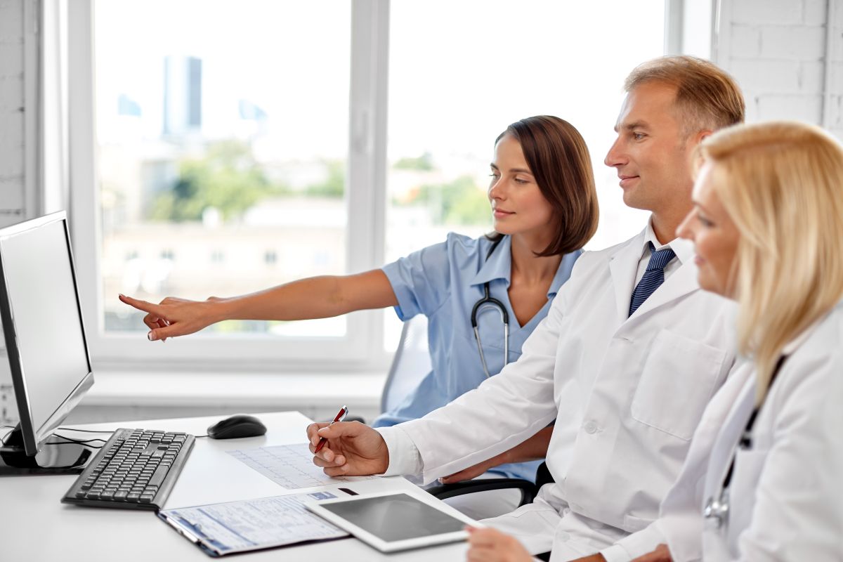 Image of medical professionals looking at a computer screen