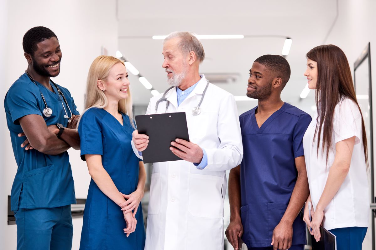 A multidisciplinary team in a hospital goes over some patient information.