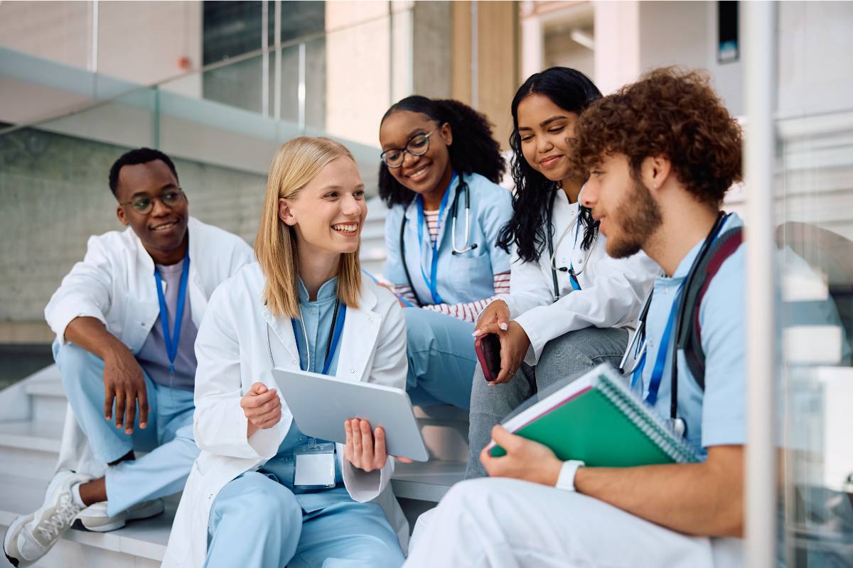 A group of students studies Myra Estrin Levine nursing theory before class.