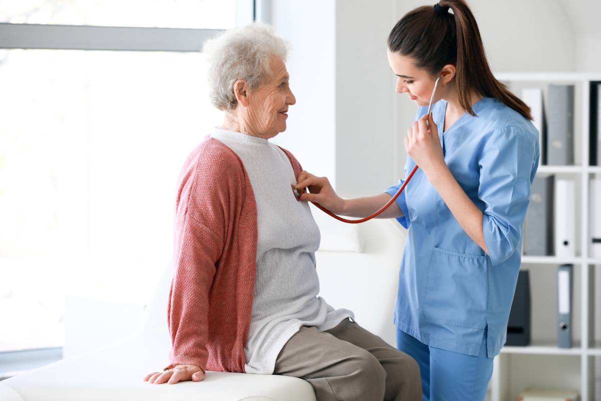 A nurse clinician assesses a patient's heartbeat.