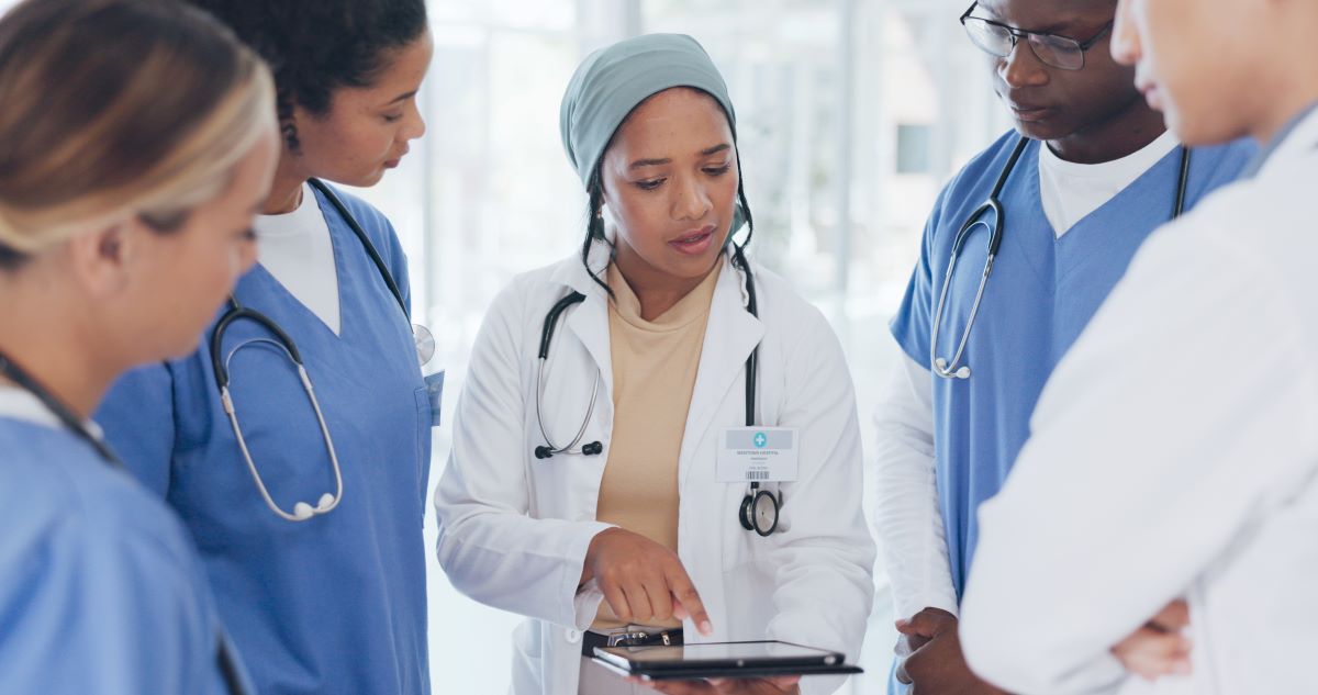 Nursing director talking to group of nurses in a healthcare facility