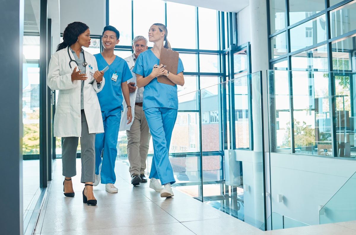 A nurse manager talks with her staff and goes over their nursing skills checklist.