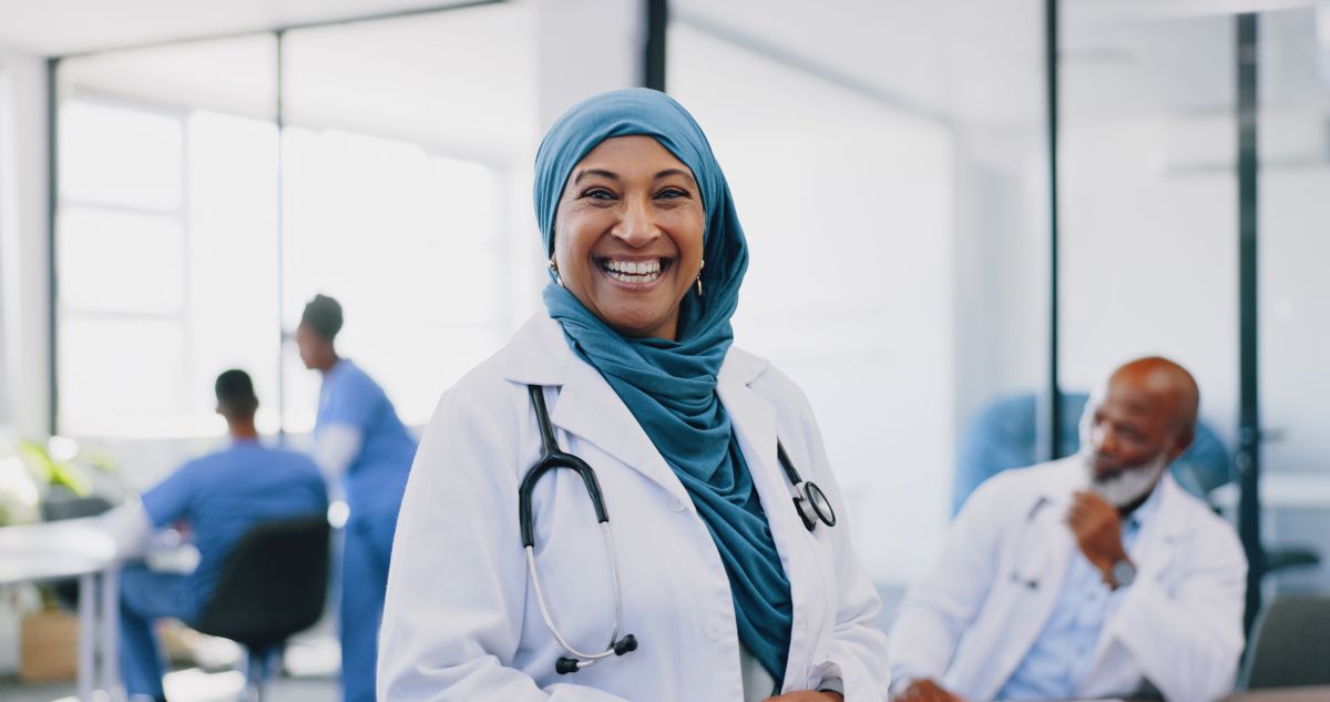 A patient flow coordinator smiling.