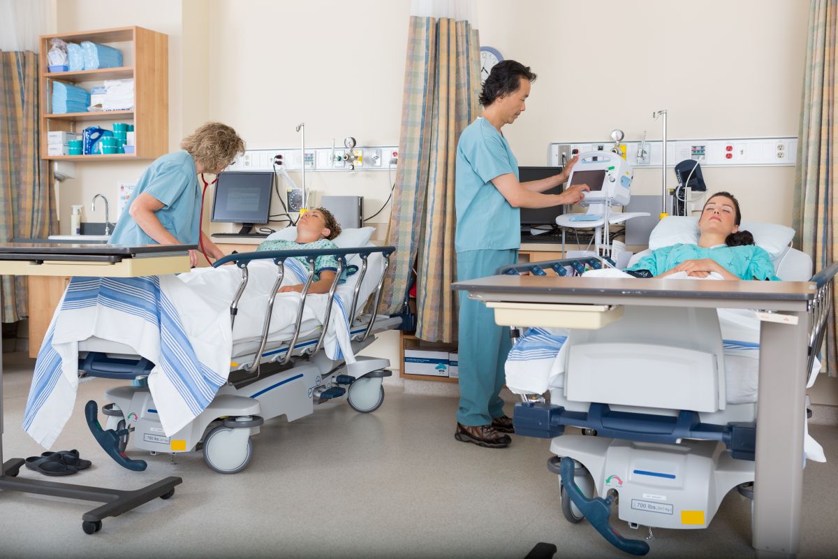 A wide angle shot of a PACU, showing the importance of optimizing patient flow in hospitals.