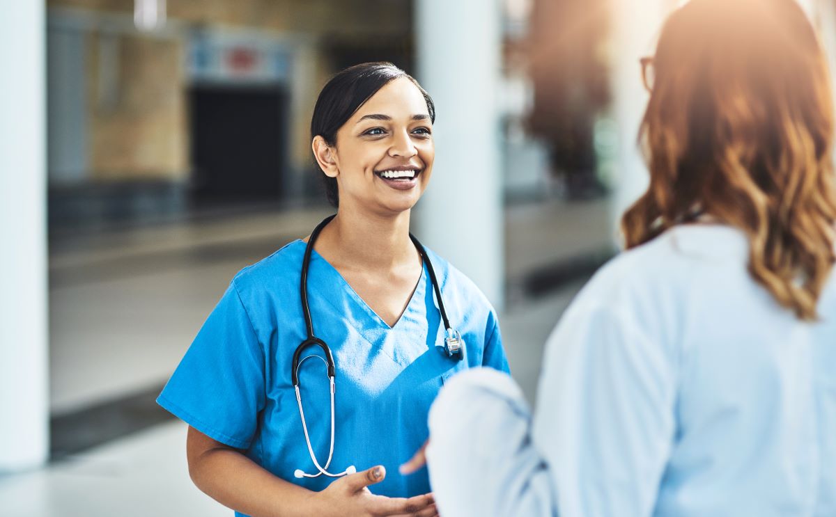 Physician and nurse discussing LPN scope of practice in a facility