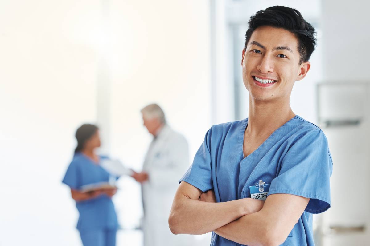 A nurse practitioner poses after submitting his PMHNP cover letter to a job application.
