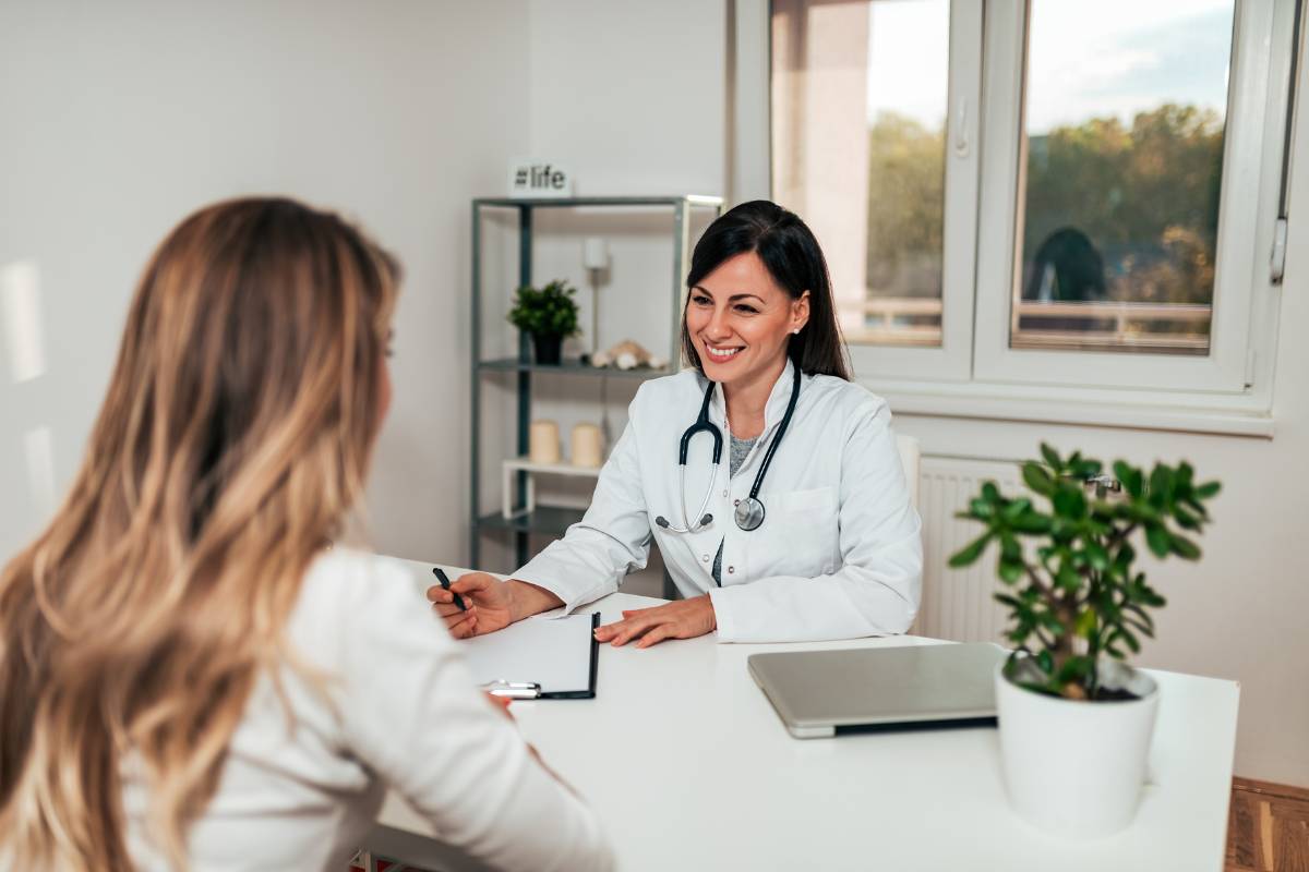 A primary care nurse practitioner speaks with a patient about their health problems.