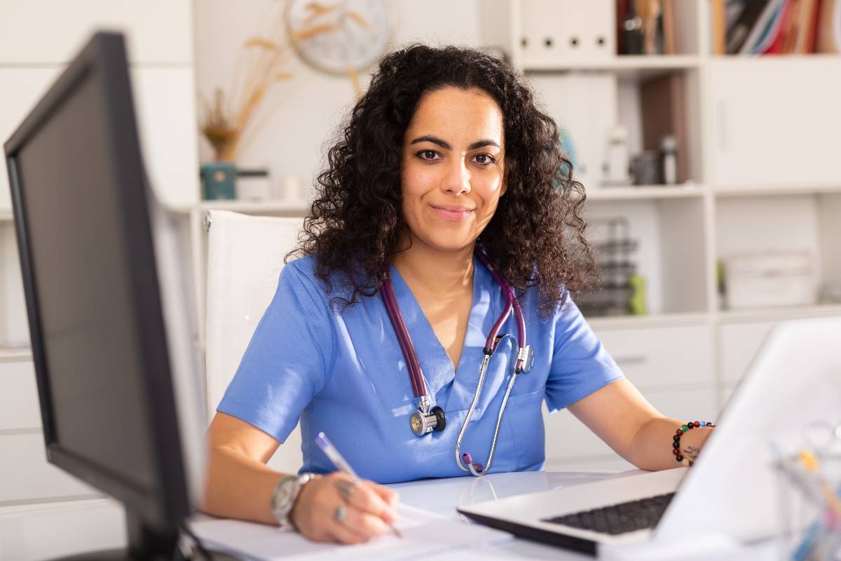 A nursing assistant works on her RMA cover letter.