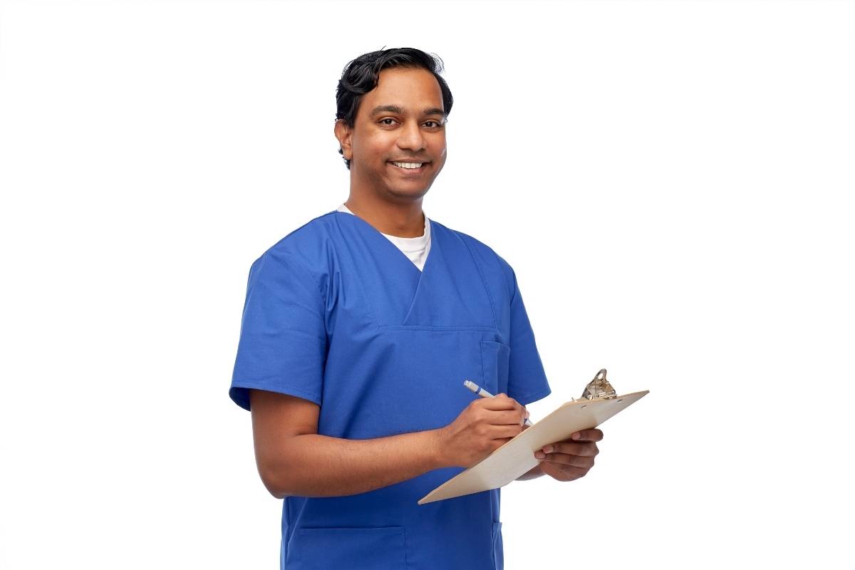 A nursing assistant works on his RMA resume.